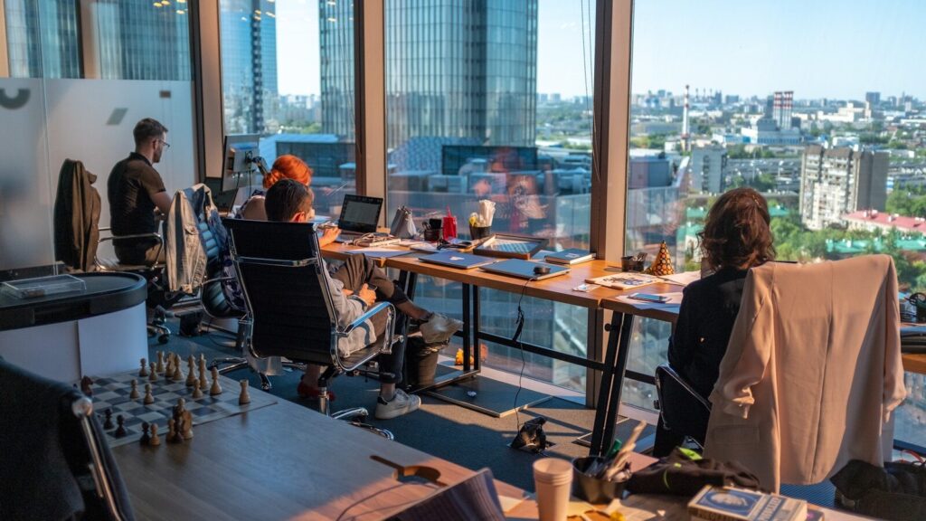 person sitting beside table in an office meeting room