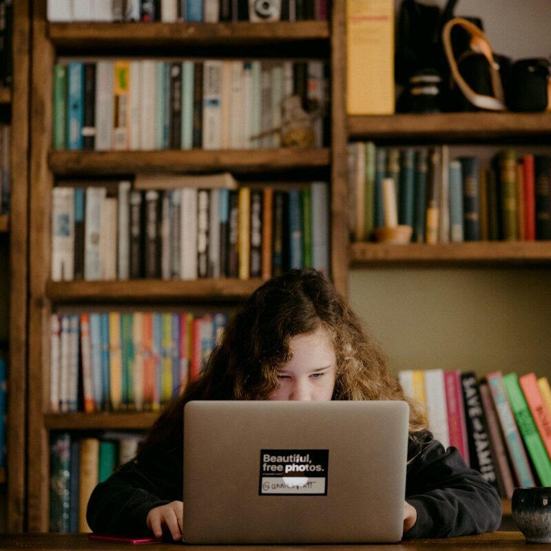 woman in black long sleeve shirt using macbook