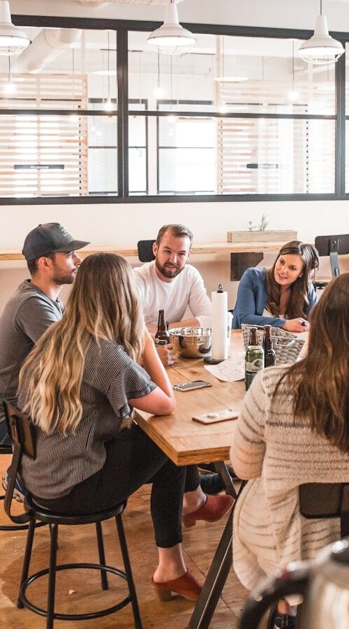 talking people sitting beside table